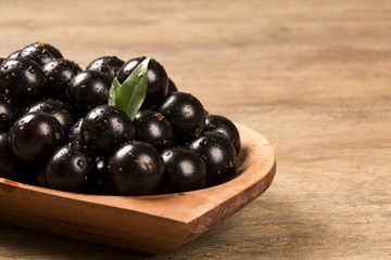 Berry Jaboticaba in bowl on wooden table