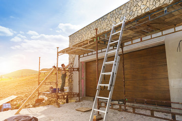 Man putting natural stones on a wall