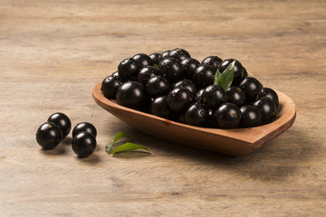 Berry Jaboticaba in bowl on wooden table