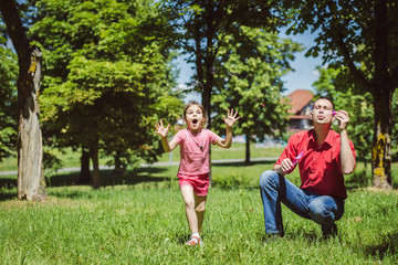Fototapeta premium Dad and his daughter are making bubbles