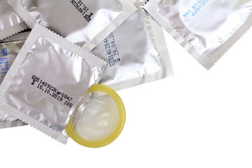 yellow condom in the package and sealed condoms