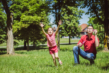 Dad and his daughter are making bubbles