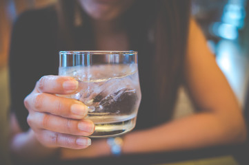 girl holding water glass