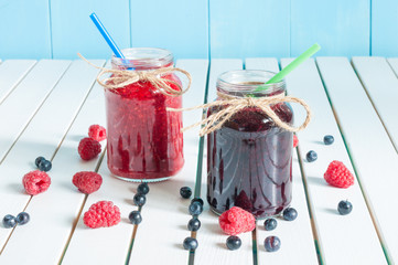 Jars of fruity jams on white background. Preserved fruits