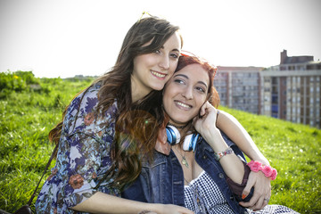 Two friends hugging outdoors