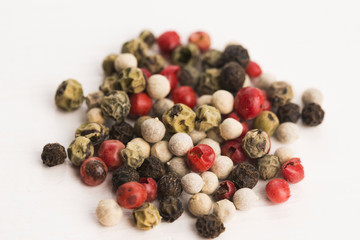 Mixed green, red, white and black peppercorns