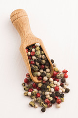 Mixed green, red, white and black peppercorns