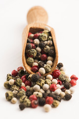 Mixed green, red, white and black peppercorns