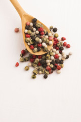 Mixed green, red, white and black peppercorns