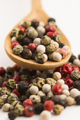Mixed green, red, white and black peppercorns