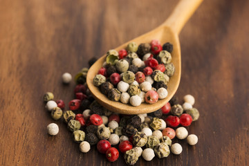 Mixed green, red, white and black peppercorns
