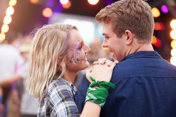 Happy couple in the crowd at a music festival