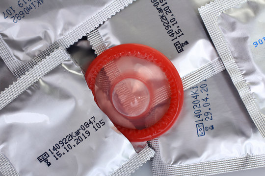 red  condom in the package and sealed condoms