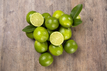 Fresh citrus lime with mint close up on wooden background