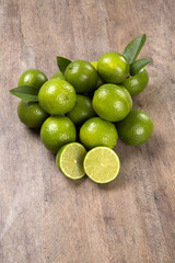 Fresh citrus lime with mint close up on wooden background