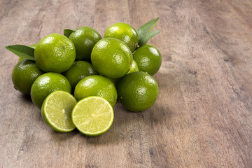 Fresh citrus lime with mint close up on wooden background