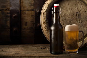 Beer barrel with beer glass on table on wooden background