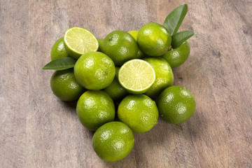 Fresh citrus lime with mint close up on wooden background