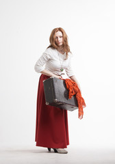 Woman in vintage red skirt with a suitcase