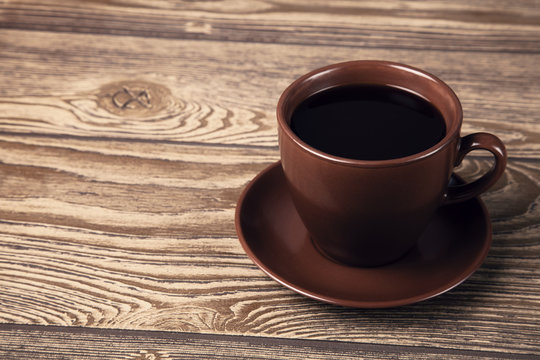 Cup of fresh espresso on wooden table