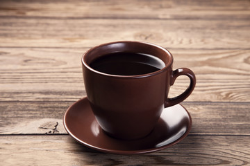 Cup of fresh espresso on wooden table
