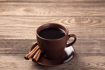 Cup of fresh espresso on wooden table