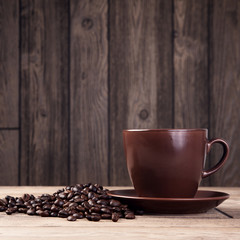 warm cup of coffee on brown background