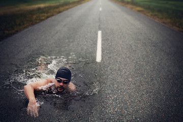 Strong Man Swim On Asphalt Road