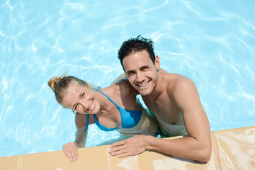 Fototapeta premium beautiful young couple in love playing together in a swimming pool