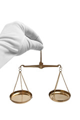 The scales of justice in his hand in a white glove