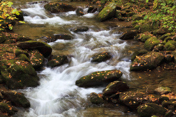 Fototapeta na wymiar Flowing Water over Rocks