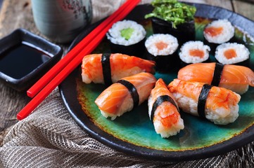 homemade sushi with wild salmon, shrimp, cucumber and seaweed. selective focus