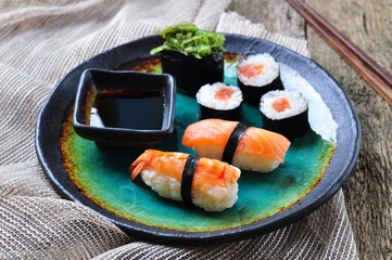homemade sushi with wild salmon, shrimp, cucumber and seaweed. selective focus