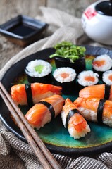 homemade sushi with wild salmon, shrimp, cucumber and seaweed. selective focus