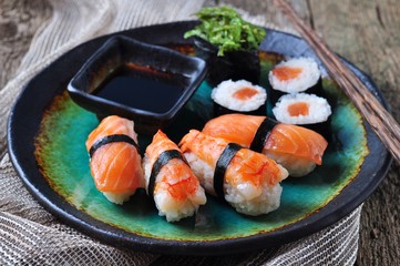 homemade sushi with wild salmon, shrimp, cucumber and seaweed. selective focus