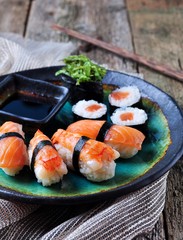 homemade sushi with wild salmon, shrimp, cucumber and seaweed. selective focus