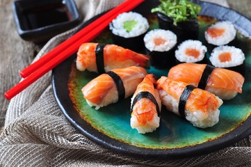 homemade sushi with wild salmon, shrimp, cucumber and seaweed. selective focus