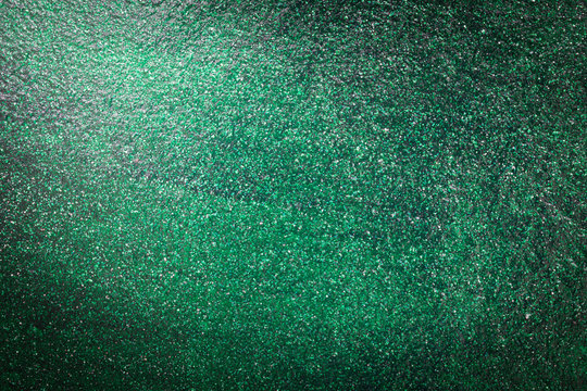 green glitter of wall cement with light from corner