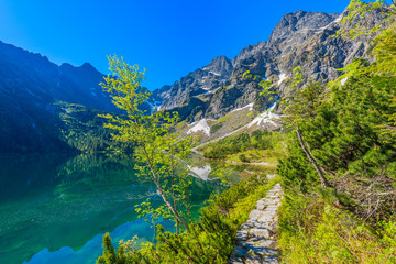 Fototapeta na wymiar Path along beautiful green water Morskie Oko lake, Tatra Mountains, Poland