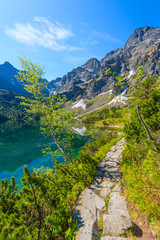 Fototapeta na wymiar Path along beautiful green water Morskie Oko lake, Tatra Mountains, Poland