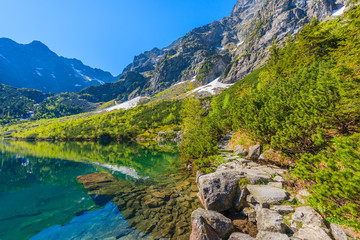 Path along beautiful green water Morskie Oko lake, Tatra Mountains, Poland
