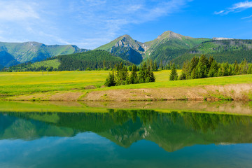 Mountain peaks reflection in water of a lake in summer landscape of Tatra Mountains, Slovakia