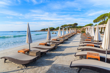 Sunbeds on sandy Palombaggia beach, Corsica island, France