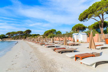 Sunbeds on sandy Palombaggia beach, Corsica island, France