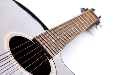 Black acoustic guitar on white background