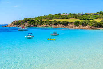 Fototapeta na wymiar Boats and kayak on turquoise sea water of Grande Sperone bay, Corsica island, France.