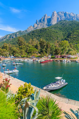 Boats in Porto harbor on sunny summer day. Porto is a small village to the west of Corsica, ideally placed for exploring this beautiful region of Corsica island, France - obrazy, fototapety, plakaty