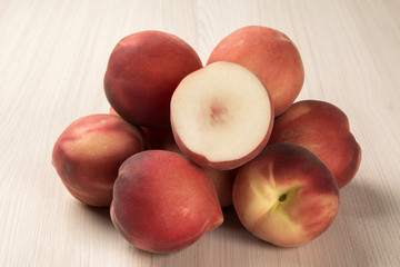 Some peaches in a basket over a white background