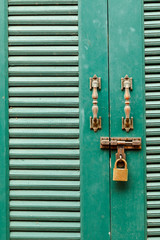 Metal bolts, latches and hooks in green wooden door