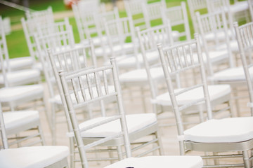 Prior to a wedding ceremony, endless white chairs 